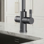 Modern kitchen faucet with a marble countertop and tiled wall.